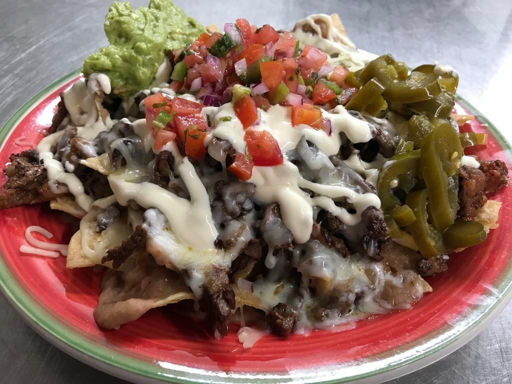 Nacho Supreme · Fresh Tortilla Chips topped with Meat, Beans, Cheese, Guacamole, Sour Cream, Jalapeno. Choice of meat: asada, Chile verde or carnitas.