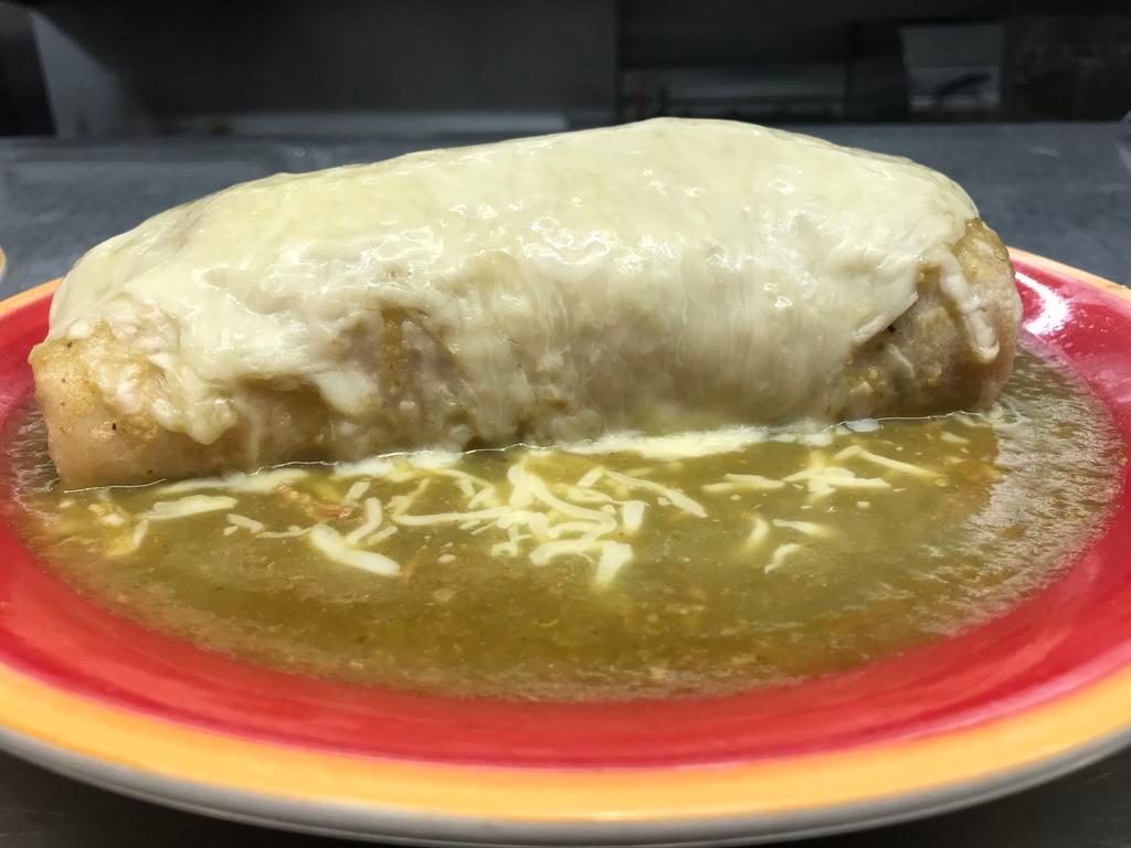 Chile Verde Wet Burrito · Tender Lean Pork Chunks, Cooked in our Mild Green Tomatillo Sauce, Beans, Rice, Topped with the same delicious Green Sauce and Melted Cheese.