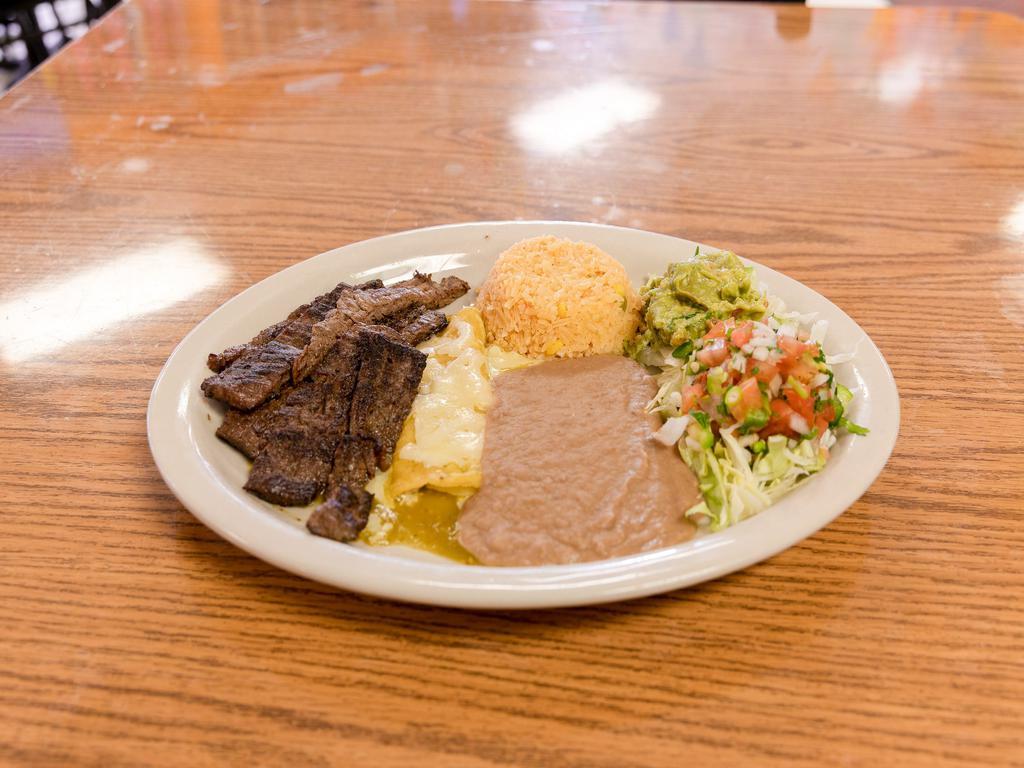 #2. Tampiquena · Beef skirts served with rice, refried beans, pico de gallo, lettuce, guacamole, tortillas and green cheese enchilada.