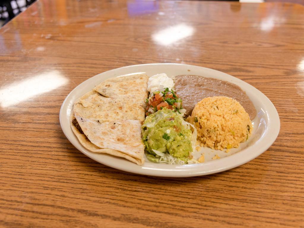 #12. Quesadilla Plate · Our big quesadilla, filled with choice of meat, served with rice, refried beans, guacamole, sour cream and pico de gallo.