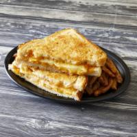 Grilled Cheese Sandwich · Cheddar and jack cheeses layered on sourdough bread buttered with garlic butter and Parmesan...
