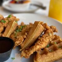 Chicken and Waffles · Golden fried chicken breast served on two Belgian waffles topped with bacon maple buffalo sa...
