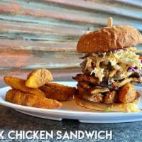 Jerk Chicken Sandwich · Grilled Chicken Thigh, Jerk Sauce, Slaw, Grilled Pineapple, Jo-Jos on Potato Bun