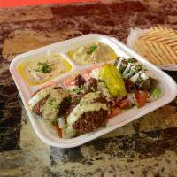 Veggie Mezza Plate & Drink · Served on Greek salad, falafel (topped with tahini sauce), grape leaves (topped with tzatzik...