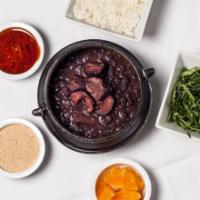 Feijoada (Stew of black beans, pork and smoked beef) · Served with white rice, collard greens and orange slices. (Feijoada completa) *No substituti...