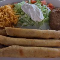 Flautas · 3 shredded chicken flautas (corn or flour) rice, refried beans, tomatoes, and sour cream.