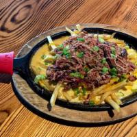 TX Smothered Fries · Shoestring Fries topped with Queso, Mixed Jack and Cheddar Cheese, Smoked Brisket, Chives an...