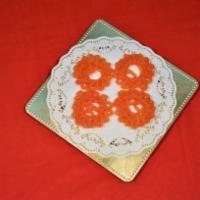 Jangiri · Orange­-colored decorative sweet in ornamental swirls, made with fine lentil and sugar syrup...
