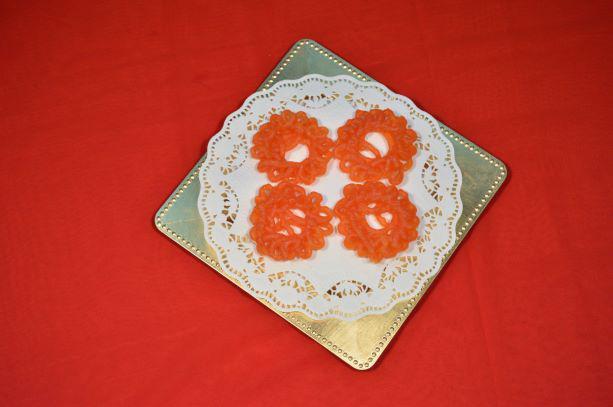 Jangiri · Orange­-colored decorative sweet in ornamental swirls, made with fine lentil and sugar syrup. Gluten free.