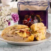 Hand Carved Turkey and Brie Cheese Sandwich Lunch Specialty · Orange cranberry glazed turkey breast with baked granny smith apple and brie cheese.