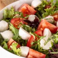 Capris Salad · Mixed greens, fresh tomatoes, mozzarella, fresh basil, dressed with a basil vinaigrette.