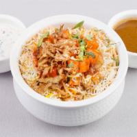 Paneer Biryani · Basmati rice cooked with cottage cheese, herbs, and spices and garnished with onions and lem...