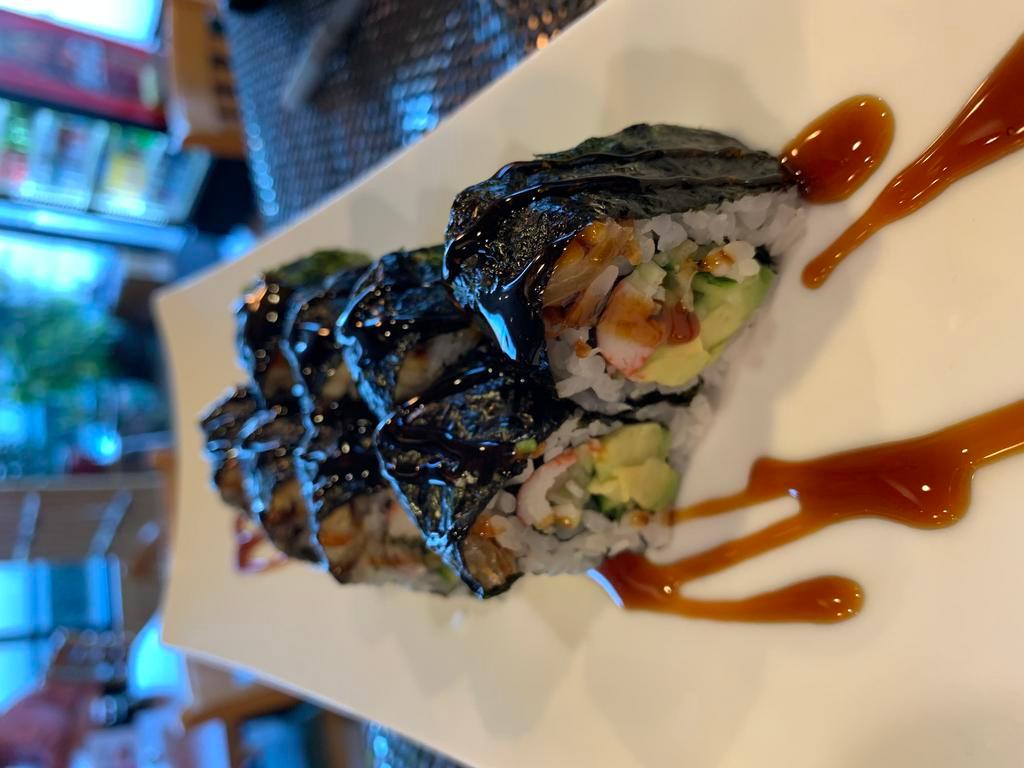 Black Dragon Roll · Crab, avocado, cucumber, topping eel and seaweed with eel sauce.
