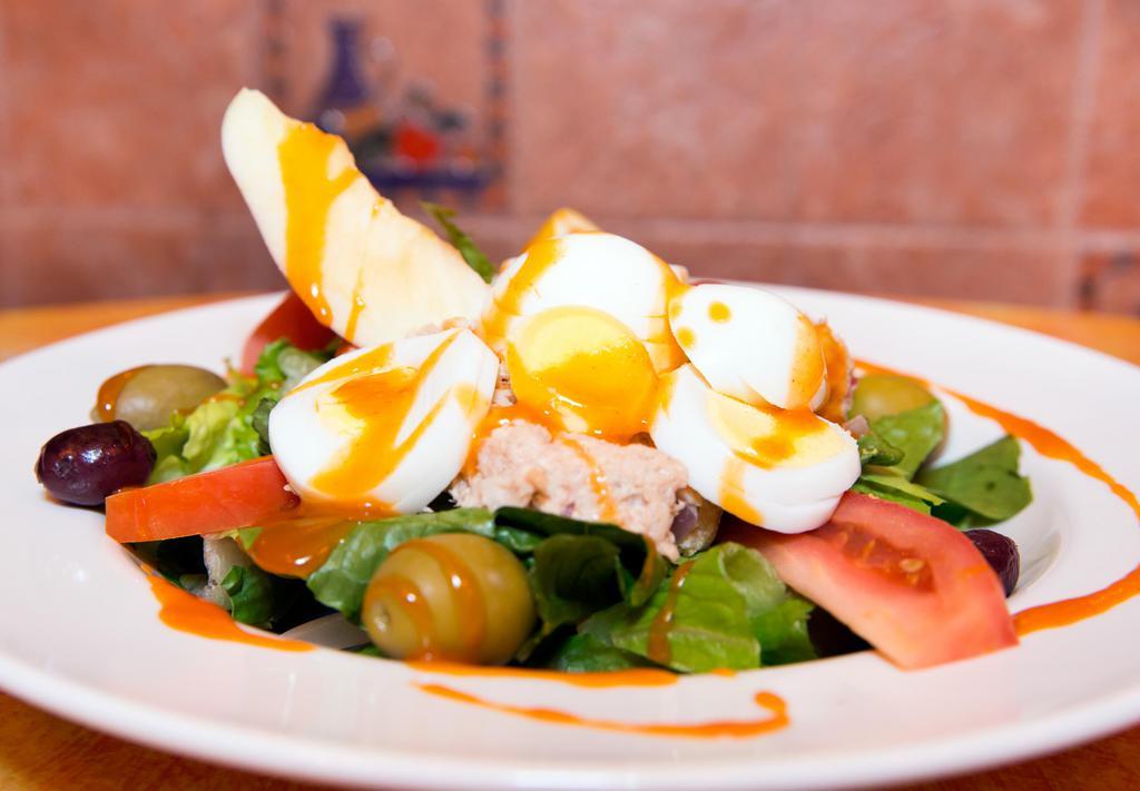 Tuna Salad · Romaine lettuce, tomatoes, Kalamata olives, hard-boiled egg, and Genova yellowfin tuna in olive oil.