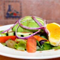 Avocado Salad · Romaine lettuce, English cucumbers, tomatoes, Kalamata olives, carrots, avocado, and red oni...