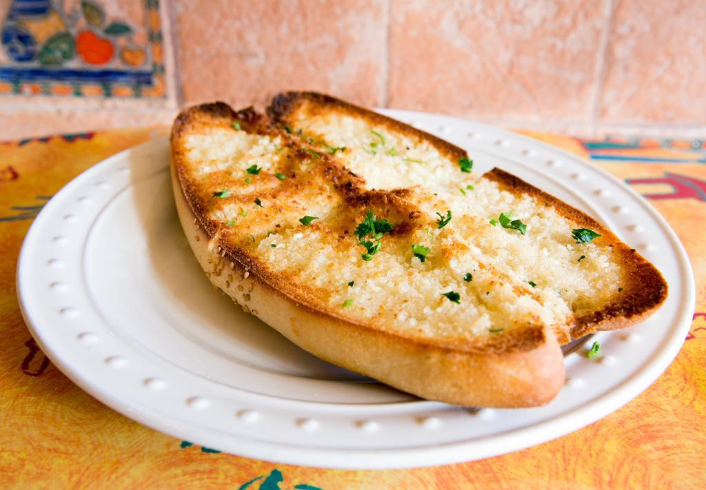 Garlic Bread · The perfect side for any pasta, our buttery garlic bread is baked in the oven with garlic, herbs and spices! Includes a side of marinara dipping sauce.