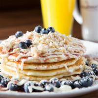 Blueberry Danish Pancakes · Danish cheese filling, blueberries, almond streusel, cream cheese frosting, and blueberry an...