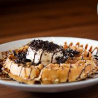 Oreo a la Mode Waffle · Vanilla ice cream, Oreo crumbles, chocolate anglaise, and caramel drizzle.