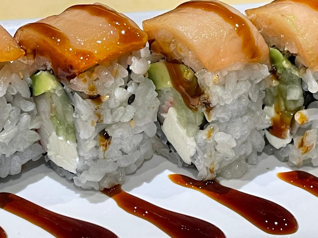9. Okc Roll · Crabmeat, cream cheese, cucumber, avocado topped with smoked salmon in oven. Cooked.