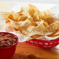 Chips and Fire-Roasted Salsa · Basket of fresh tortilla chips seasoned with Fuzzy Dust, and served with fire roasted salsa.