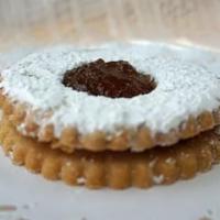 Linzer Tart · Rich and buttery Linzer cookies with a layer of seeded raspberry or apricot jam.