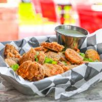 Boudin Chips · Bold & spicy boudin, sliced, dusted in flour & crispy fried. Finished w/ Cajun spices.