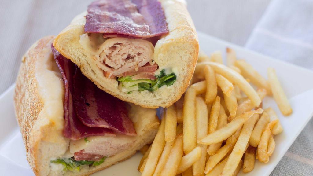 Club Sub · Turkey, ham, bacon and cheese with mayo, lettuce, tomatoes and onions.