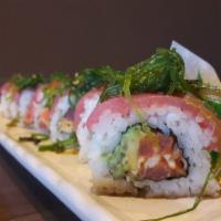 Poki Roll · Spicy imitation crab, cucumber, & avocado roll topped w/ tuna & seaweed salad.