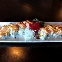 Sunset Roll · Shrimp tempura and imitation crab roll topped with salmon, sliced lemon, eel sauce and spicy...