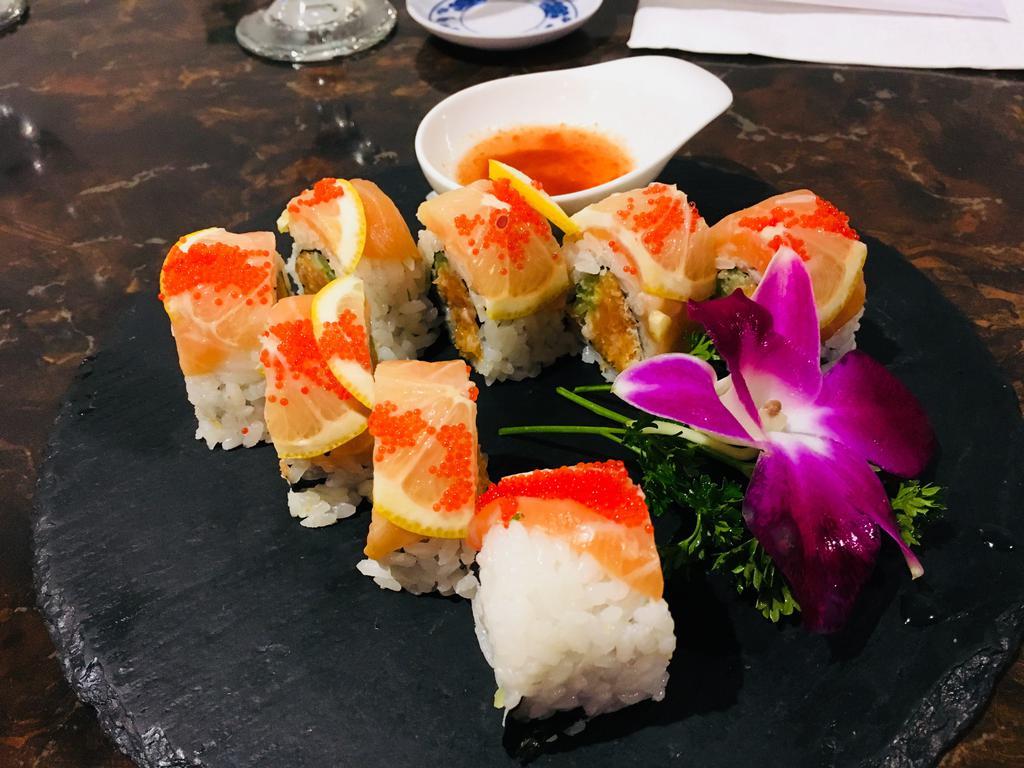 R25. Salmon Lover Roll · Spicy salmon, cucumber, daikon sprout, top with fresh salmon, thinly sliced lemon, red tobiko served with spicy ponzu sauce on the side.
