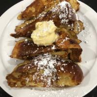 French Toast · Sweet Challah Bread dipped in our homemade vanilla custard, toasted to a golden brown.
Toppe...
