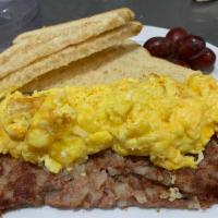 Corned Beef Hash · Traditional crispy corned beef hash topped with eggs any style. Served with white or wheat t...