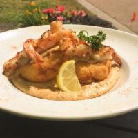 Shrimp & Grits · Five jumbo white gulf shrimp over creamy cheddar cheese fried grit cakes, topped with chef's...