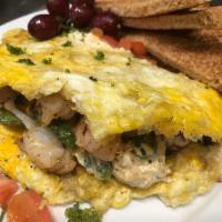Seafood Omelette · Fluffy three egg omelette layered with baby spinach and stuffed with Maryland crab, white gu...