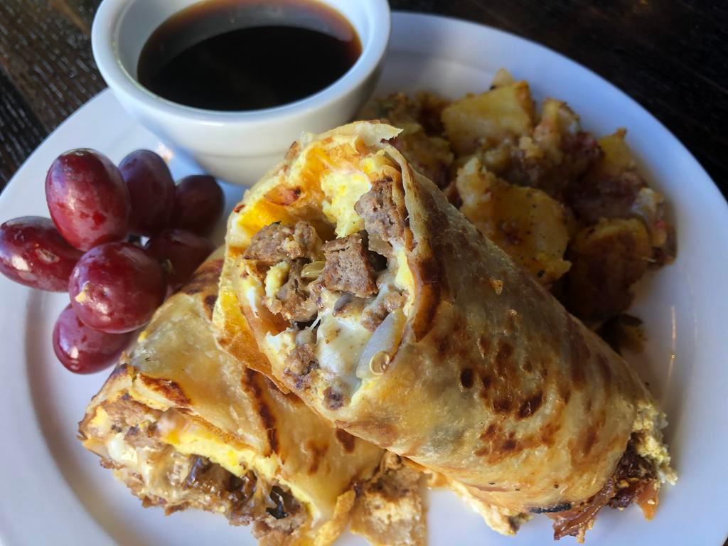 Breakfast Burrito · Juicy grilled rib eye and onions with Swiss cheese, drizzled with spicy jumpin' sauce. Wrapped in a fried egg tortilla  and served with Au jus for dipping this delicious burrito. Includes Yukon gold country potatoes.