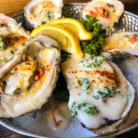 Rockefeller Oysters · 6 Buttery Local oysters topped with creamy Parmesan, wilted baby spinach and garlic with cri...