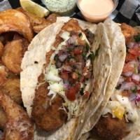 Battered Fish Tacos · 10 oz of beer battered fried cod topped with freshly made mango slaw and house pico. Comes w...
