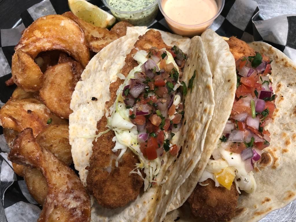 Battered Fish Tacos · 10 oz of beer battered fried cod topped with freshly made mango slaw and house pico. Comes with Cilantro Lime and Jumpin Sauce. Served with Garlic Parmesan Fries.