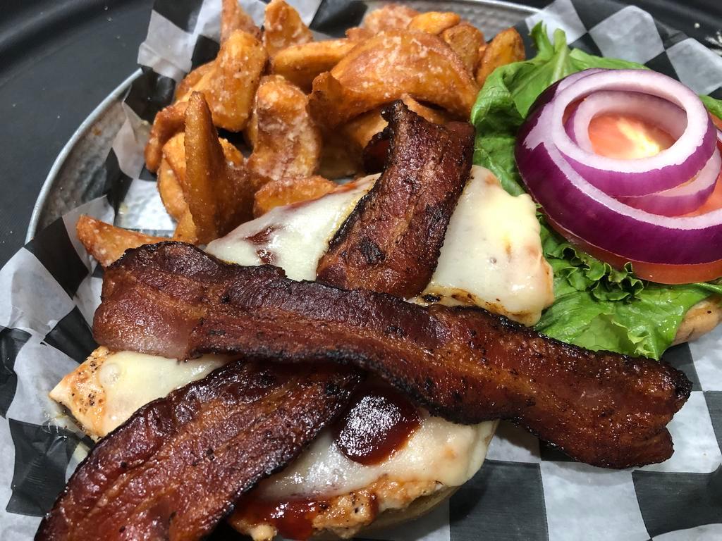 Grilled Chicken Sandwich · Grilled chicken breast topped with Applewood bacon, tangy BBQ, and Swiss cheese with lettuce, onion, and tomato on a brioche bun. Served with Garlic Parmesan Sidewinder fries. 