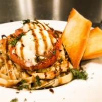 Chicken Caprese · Tender chicken breasts topped with basil pesto, grilled tomato and mozzarella cheese. Served...