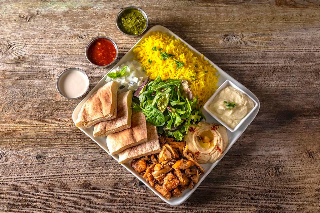 Protein Plate · With your choice of protein, the plate comes with turmeric rice, pita bread, hummus, tzatziki, garlic spread, mixed greens, balsamic vinaigrette, tahini sauce, cilantro mint chutney, and peri peri hot sauce.
