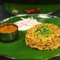 Egg Kothu Parotta · Parottas and egg, chopped up on the grill with spices.