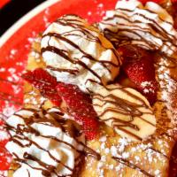 THE FAMOUS CREPE - Strawberry, Banana, Nutella, Ice Cream and Whipped Cream Crepe · 