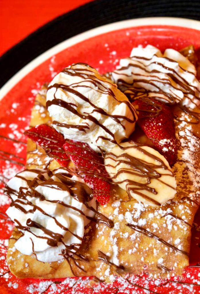 THE FAMOUS CREPE - Strawberry, Banana, Nutella, Ice Cream and Whipped Cream Crepe · 