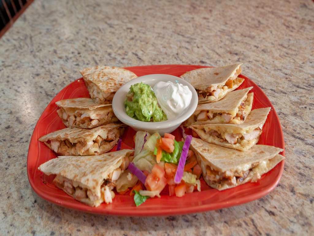 Beef Fajita Quesadillas · 2 tortillas filled with Monterey cheese and beef fajita. Served with guacamole and sour cream.