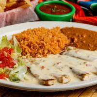 Chicken White Queso · Grilled chicken breast topped with white queso and served with 1 tamale.