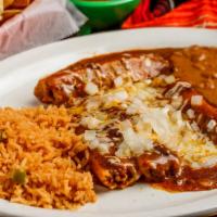 Tamale Supreme · 3 large tamales covered with chili gravy, cheese and onions.