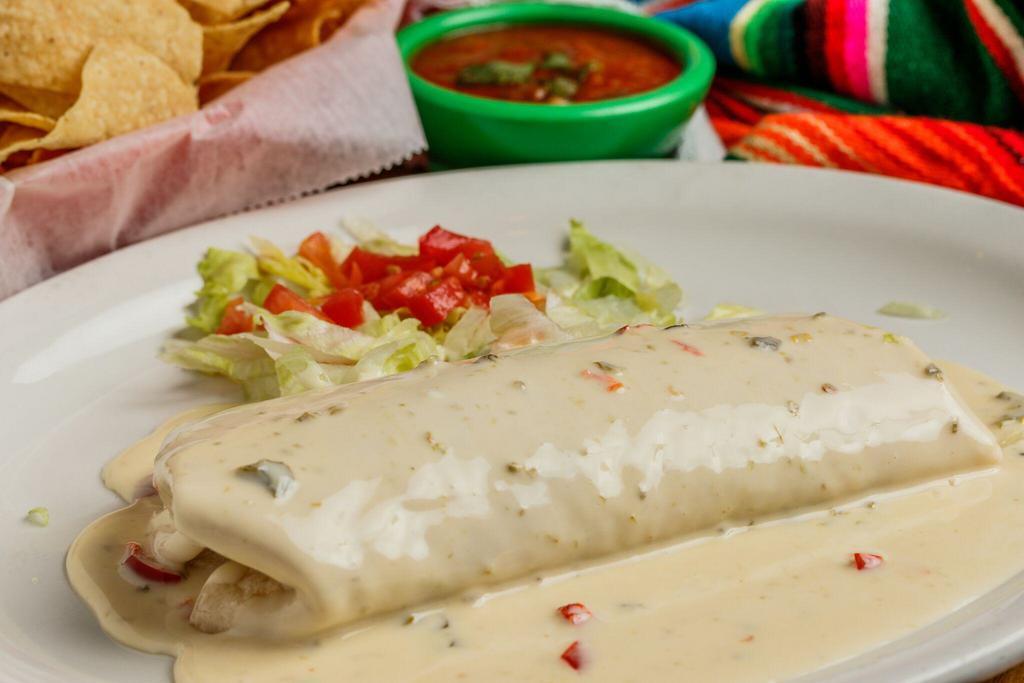 White Queso Donkey · Large flour tortilla stuffed with grilled chicken, beans and rice, topped with jalapeno white queso sauce.