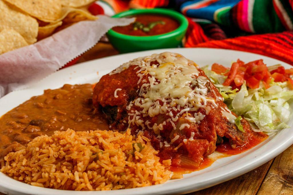 Chile Relleno · Poblano pepper stuffed with spiced ground beef, chicken, beef fajita or grilled shrimp covered with red sauce and Monterrey cheese, served with rice, beans and tortillas.
