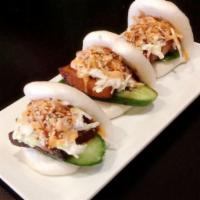 Pork Buns · Slice of savory pork belly dressed with Bonchon Soy Garlic Sauce, topped with cucumbers, col...